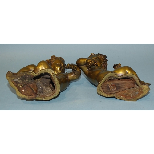 137 - A pair of bronze cherubs in a reclining posture, holding wheatsheaf and grapes, 14cm high, (clock or... 