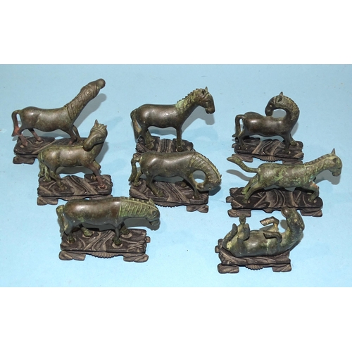 138 - A collection of eight Oriental bronze models of horses, on carved wood bases, (8).