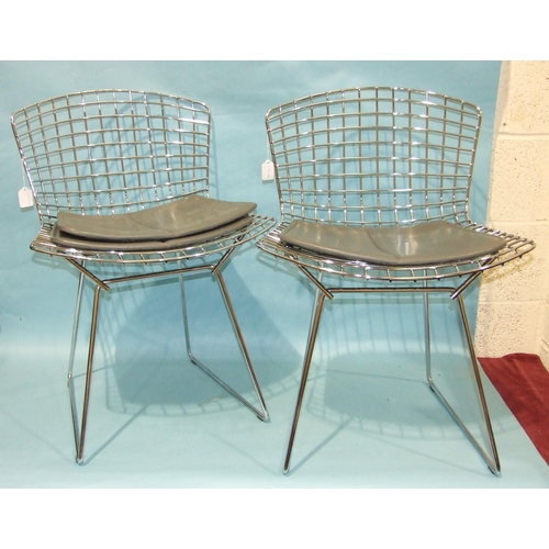 27 - A pair of side chairs designed by Harry Bertoia, the chrome plated frames with grey leather seat pad... 