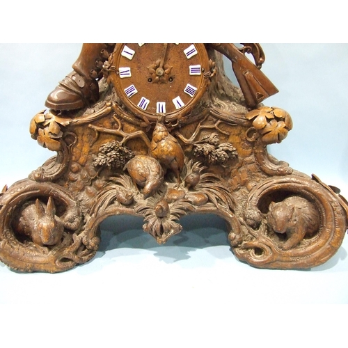 91 - A large and impressive carved wood Black Forest clock, the circular dial with enamelled numerals and... 