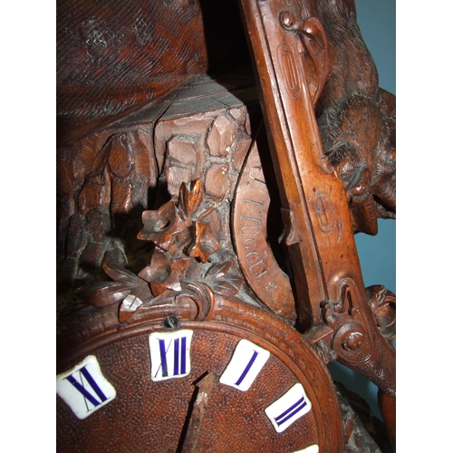 91 - A large and impressive carved wood Black Forest clock, the circular dial with enamelled numerals and... 