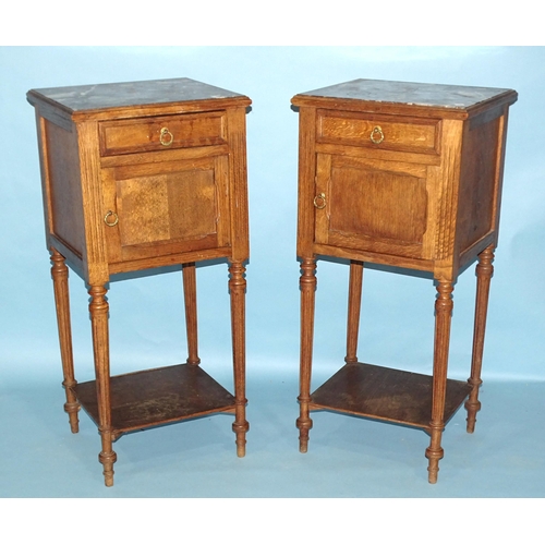 25 - A pair of late-19th century walnut French pot cupboards, each with marble top, single drawer and por... 