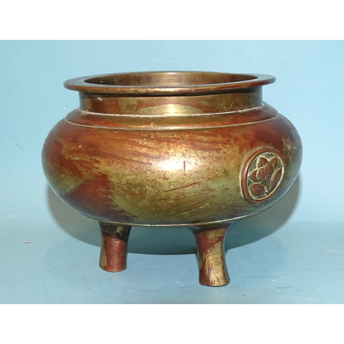 140 - An Oriental bronze censer with floral bosses, 12.5cm diameter, 9.5cm high.