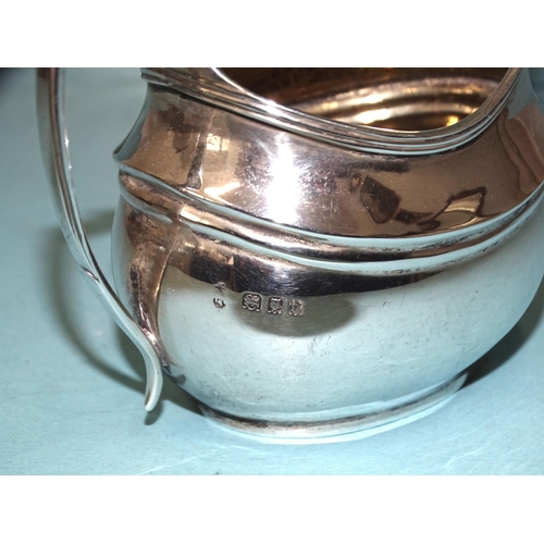 531 - A George V silver three-piece bachelors tea service of plain compressed oval form, maker's marks rub... 