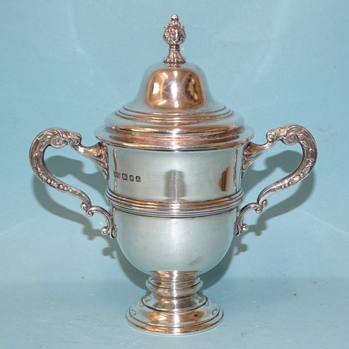 532 - A George VI small silver trophy cup and cover with ribbed decoration and scroll handles, maker Danie... 