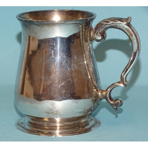 564 - A George II silver half-pint tankard of baluster form, with leaf-capped scroll handle, inscribed mak... 