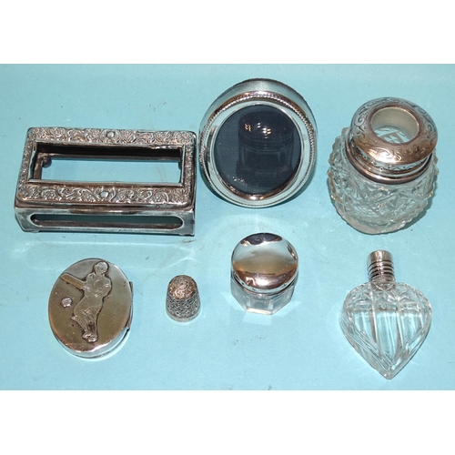 566 - An embossed silver matchbox holder, Chester 1905, a cut-glass heart-shaped scent bottle with stopper... 