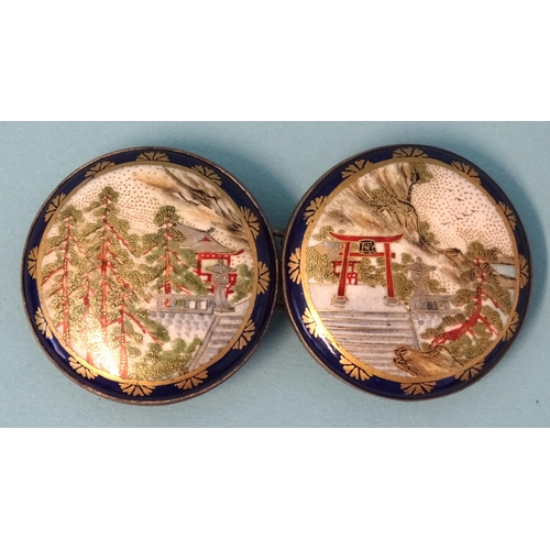 795 - A Japanese Satsuma porcelain two-piece buckle, each circular plaque depicting buildings, torii gate ... 