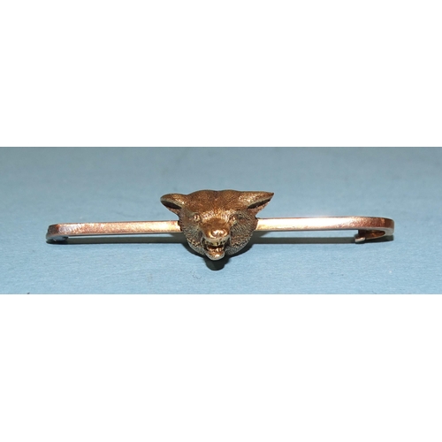 812 - A gold fox mask bar brooch marked '15ct' on bar, (pin missing), 8.9g.