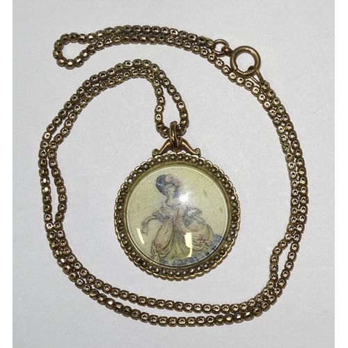 859 - A circular 9ct gold locket enclosing a miniature of a lady in 17th century dress, within seed pearl ... 