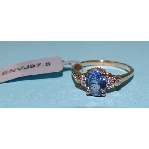 865 - A Ceylon-blue sapphire and white zircon ring claw-set a heat-treated sapphire between triplets of zi... 