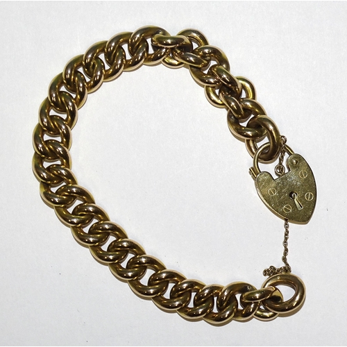 907 - A 9ct gold hollow curb-link bracelet with padlock clasp, 20cm, 27.8g.