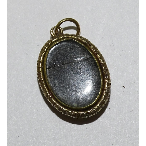 929 - A small gold religious pendant, (tests as 18ct approximately), on unmarked curb-link chain, tests as... 