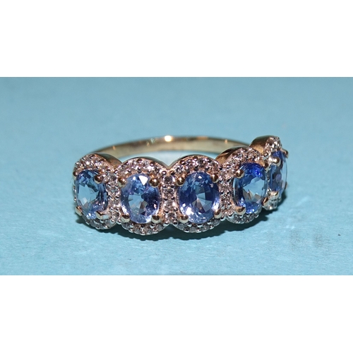 931 - A sapphire and white zircon ring of five oval heat-treated Ceylon sapphires, each bordered by zircon... 