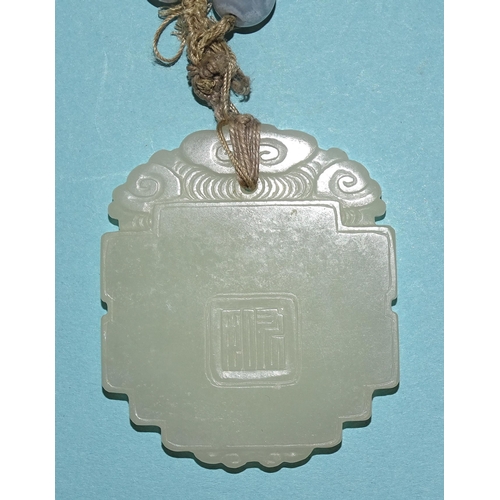 799 - A Chinese celadon jade and blue agate necklace, the pendant of shaped oval form, carved in low relie... 