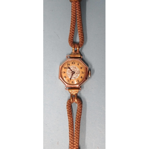 682 - A lady's 9ct-gold-cased octagonal wrist watch on cord strap, gross weight 13.8g.