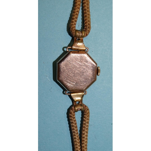 682 - A lady's 9ct-gold-cased octagonal wrist watch on cord strap, gross weight 13.8g.