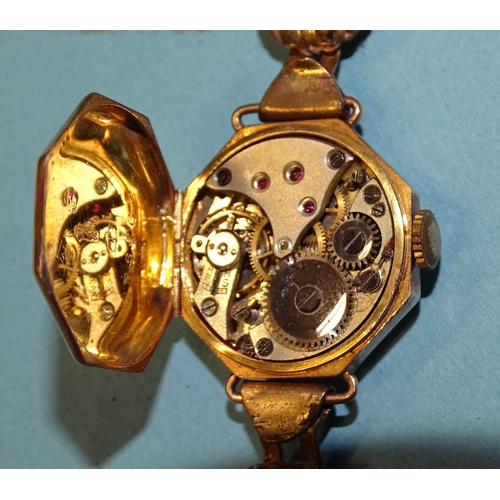 682 - A lady's 9ct-gold-cased octagonal wrist watch on cord strap, gross weight 13.8g.