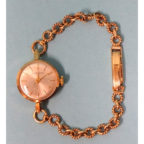 701 - Garrard, a lady’s 9ct-gold-cased wrist watch on 9ct gold bracelet of circular rope-twist links... 