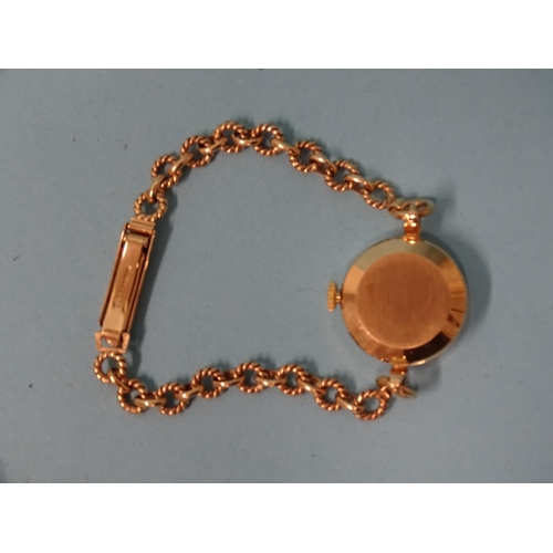 701 - Garrard, a lady’s 9ct-gold-cased wrist watch on 9ct gold bracelet of circular rope-twist links... 