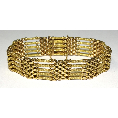 845 - A Victorian 15ct gold gate-link bracelet of textured and smooth links, with concealed clasp, 21cm lo... 