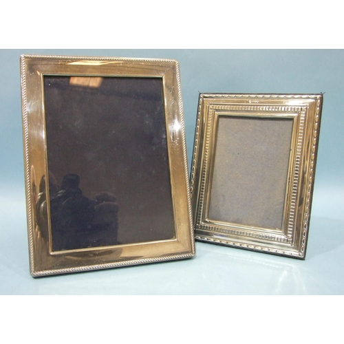 524 - A modern silver photograph frame of plain form, with reeded edge, 22 x 17cm, Sheffield 1994 and a sm... 