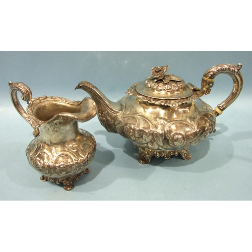 527 - A Victorian silver teapot of compressed form, with overall embossed floral decoration, the hinged li... 