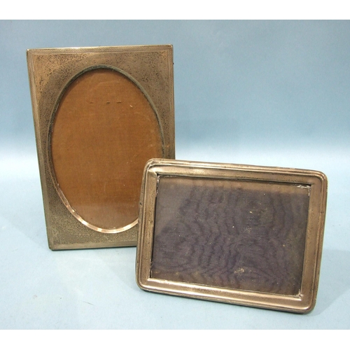 553 - A rectangular silver photograph frame, Birmingham 1924, 12 x 16cm, (small dents) and another with ov... 