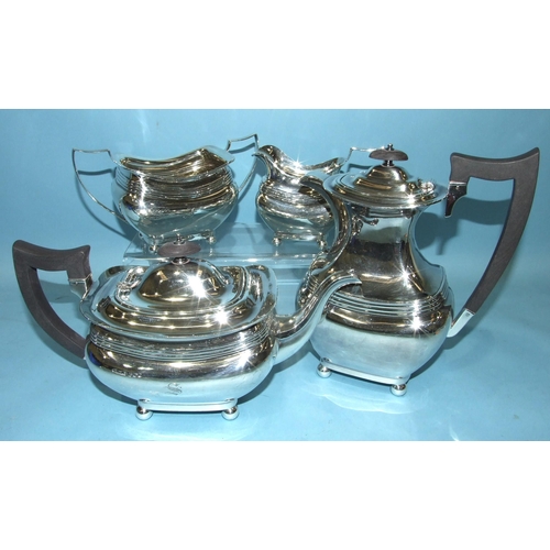 561 - A 20th century four-piece silver tea service of bellied and reeded form, raised on four ball feet, b... 