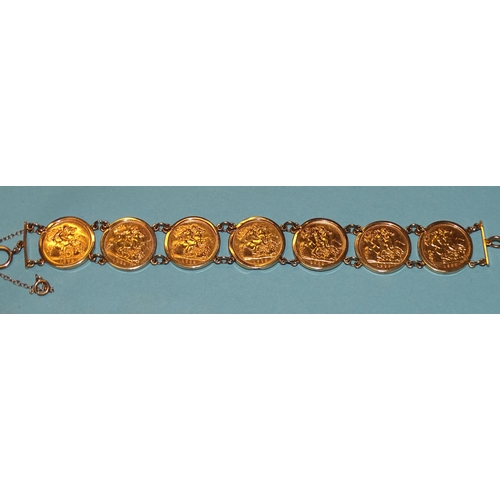 655 - A 9ct gold bracelet set seven half-sovereigns, all 1982, total weight 38.8g.