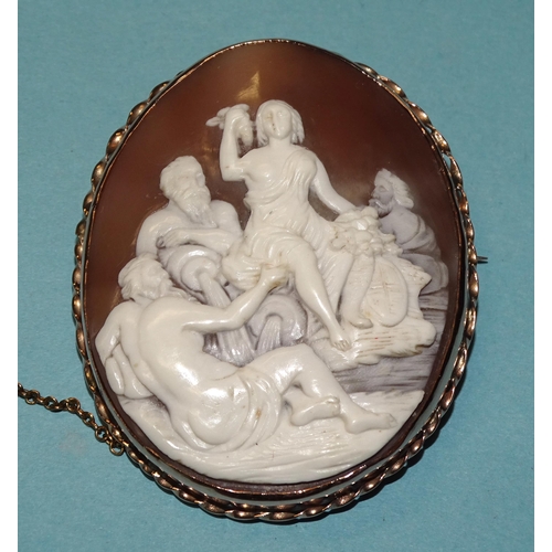 822 - A carved shell cameo brooch depicting a Bacchanalian scene, in unmarked gold rope-twist mount, 60 x ... 