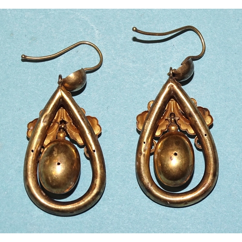 854 - A pair of Victorian yellow metal earrings of drop form, with oval bead suspended within hollow frame... 