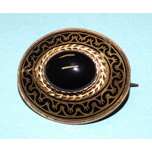 855 - A Victorian mourning brooch set oval onyx cabochon within black enamelled border, with locket back, ... 