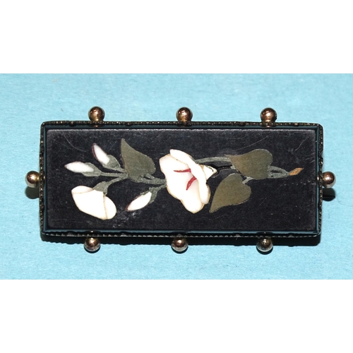 870 - A Victorian gold-mounted rectangular pietra dura brooch depicting lilies.