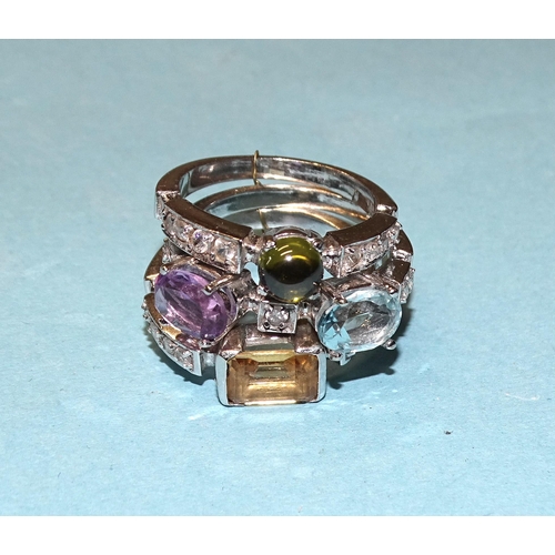 883 - A set of three 14ct white gold stacking rings set blue topaz, amethyst, citrine, tourmaline and synt... 