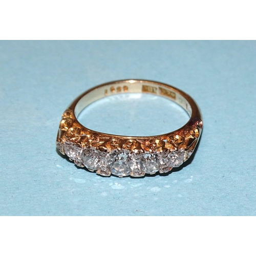 904 - An 18ct gold ring set five graduated old brilliant-cut diamonds, with diamond points between, in scr... 