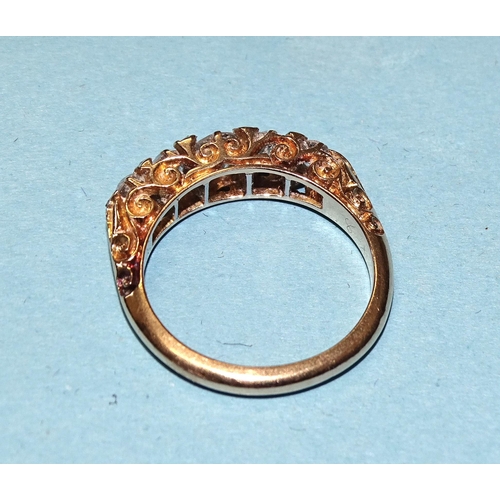 904 - An 18ct gold ring set five graduated old brilliant-cut diamonds, with diamond points between, in scr... 