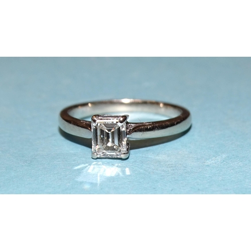 932 - A solitaire diamond ring claw-set an emerald-cut diamond of approximately 0.62cts, in 18ct white gol... 