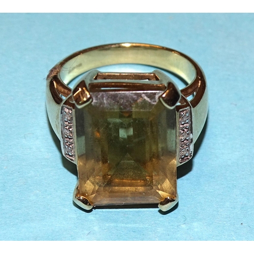 934 - A citrine and diamond dress ring claw-set an emerald-cut citrine between diamond accent-set shoulder... 