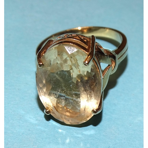 938 - A citrine dress ring claw-set an oval citrine of 9.16cts, in 9ct yellow gold mount, size N, 6.9g, wi... 