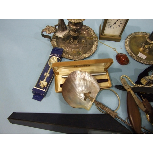 151 - Two plated chambersticks, a white metal and mother-of-pearl shell spoon, a brass carriage timepiece ... 