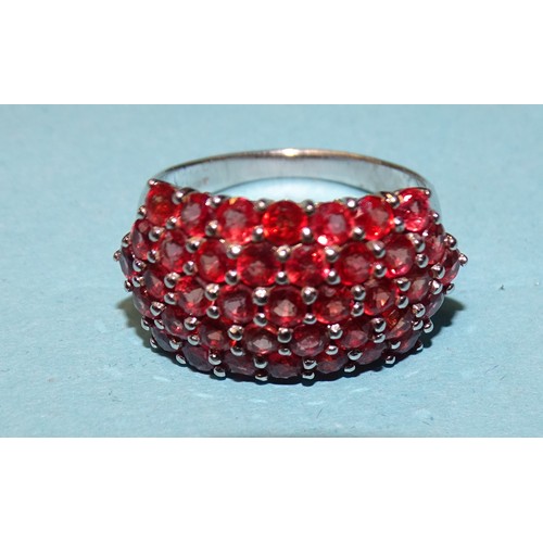 75 - A 9ct white gold ring set a cluster of thirty-nine round-cut rubies, size N½, 4.9g.