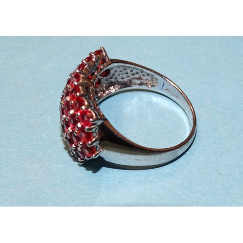 75 - A 9ct white gold ring set a cluster of thirty-nine round-cut rubies, size N½, 4.9g.