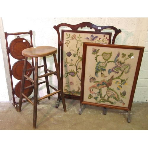 12 - Two needlework fire screens, a three-tier folding cake stand, a high stool and a large wool-work pan... 