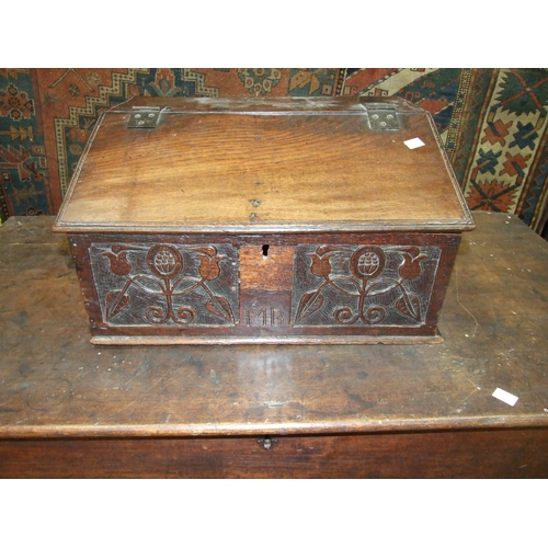 16 - An antique oak bible box, the front carved with stylised flowers and initials MB, 55cm wide, 29cm hi... 