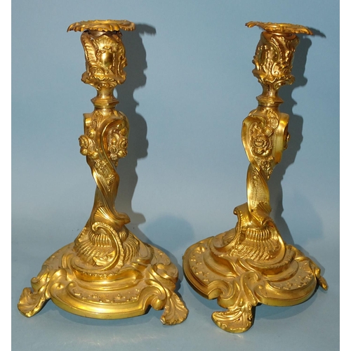 55 - A pair of gilt metal Rococo-style candlesticks, 29cm high.