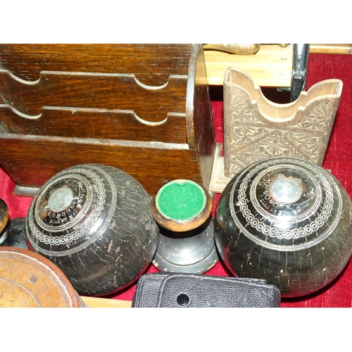 57 - Two ebony bowling balls by Jacques of London, with inscribed white metal mounts, on stands numbered ... 