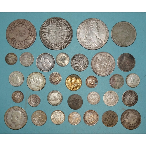 94 - A small collection of foreign silver coinage, including a M. Theresa 1-Thaler, a one-Yen coin, other... 