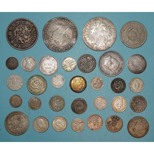 94 - A small collection of foreign silver coinage, including a M. Theresa 1-Thaler, a one-Yen coin, other... 