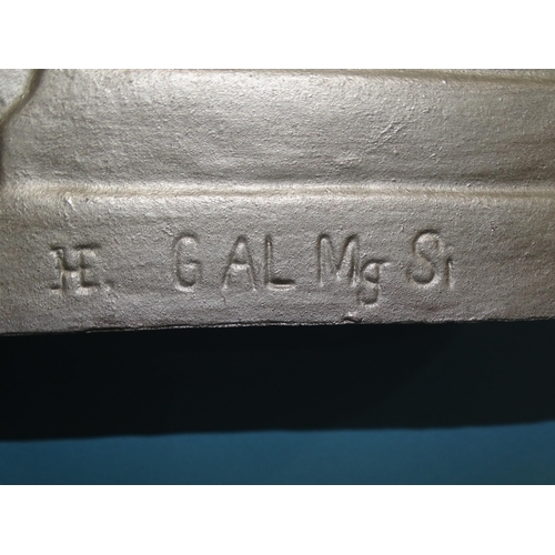 554 - A WWII Third Reich cast alloy eagle and swastika insignia, incised on reverse HE (monogram) G AL Mg ... 